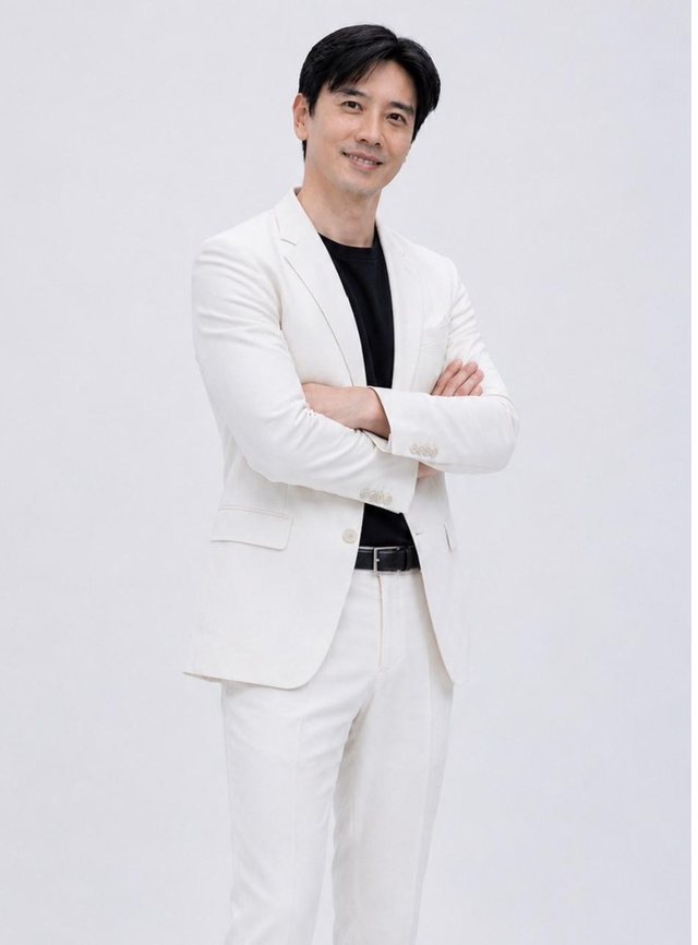Dato' Seri Ivan Teh in a white suit, arms folded, studio portrait